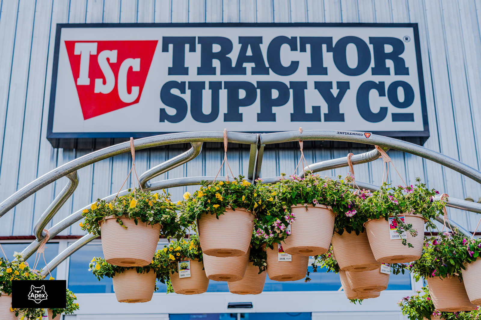 Tractor Supply Co. signage with hanging flower baskets at the Bangor Dog Shelter adoption event