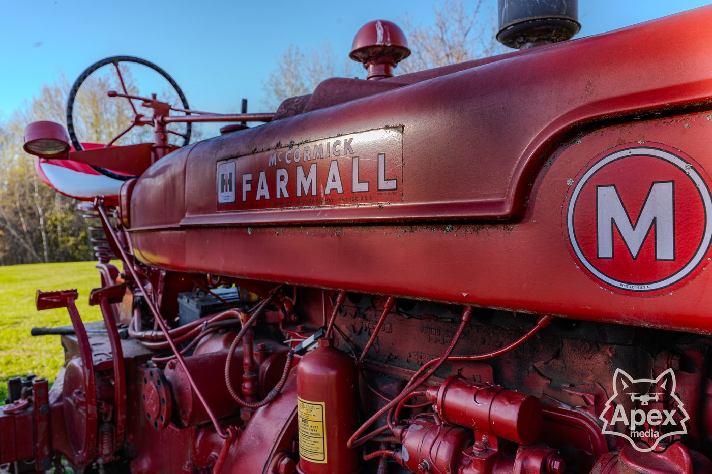 Vintage Farmall M tractor, dramatic HDR sky